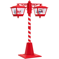 Ce lampadaire rouge et blanc présente deux lanternes décoratives inspirées de Noël.